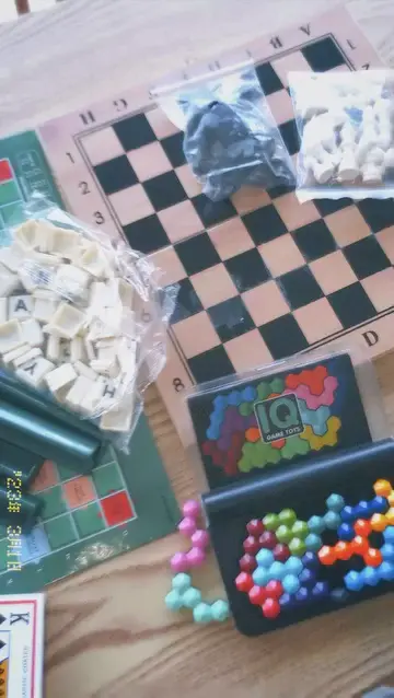 Chess, Scrabble, UNO and other board games spread across a café table