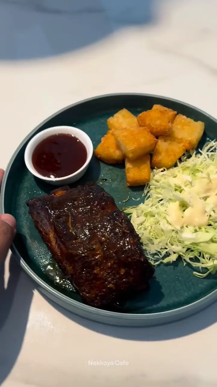 Baby back ribs plated with fries and slaw at the Nekkoya Café